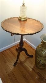 Vintage Pie crust side table features a sculptural edge around the top. Antique.