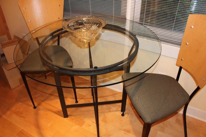 Small round glass top table and two chairs; contemporary style