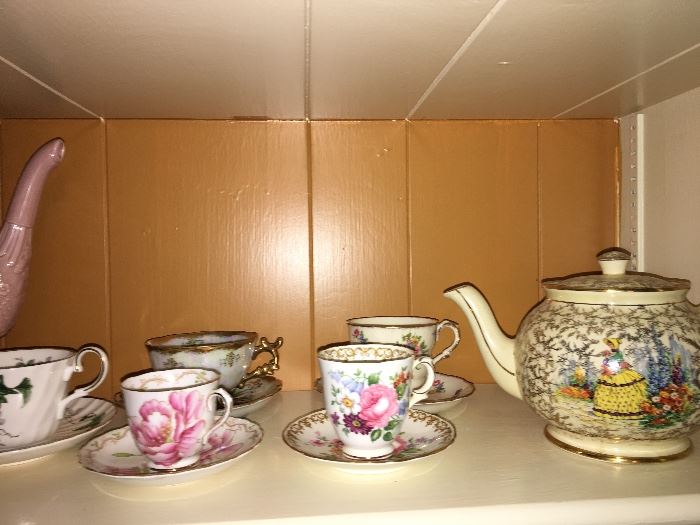 detailed hand-painted porcelain teacups and tea pitcher