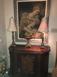 Beautiful Mother and children painting, Renaissance style. Footed fruit bowl, two small table lamps with bias twisted silk shades atop a small solid, heavy wood console. Note the Moroccan panel on console front. ( NO PRICE QUOTES  AND NO HOLDS SO PLEASE DON'T ASK :-))