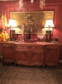Huge Antique French  sideboard, with framed, four-panel Asian silk screen above. Three Asian figurines in foreground. Two lamps with bordered silk shades. Tribal neck piece on stand. (NO PRICE QUOTES  AND NO HOLDS SO PLEASE DON'T ASK :-))