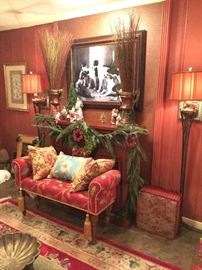 a floral upholstered bench with tassels is covered with pillows and sits at the edge of a silk rug. Christmas décor is featured on the mantel above it. Framed above is a classic dog painting.  Note those knock out standing lamps with russet silk shades ! ( NO PRICE QUOTES  AND NO HOLDS SO PLEASE DON'T ASK :-))
