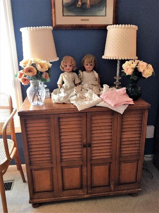Vintage dresser with slide out tray shelves, vintage boudoir lamps, antique dolls from 1930's, antique baby clothes