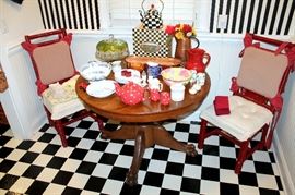 Round oak claw-foot table, red painted chairs