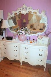 White dresser and large ornate mirror