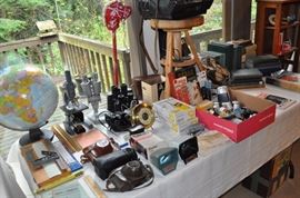 World globe, microscopes, cameras, photo equipment.