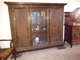 large library cabinet with shelving storage on two sides and glass display area in the center; this piece is large