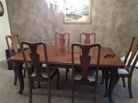 wonderful 6' dining table (with leaf extended); and six chairs with spoon feet; uses a crank to roll out the table and either remove ad insert the leaf.