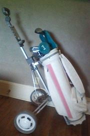 Complete set of Ladies Rawlings gold clubs with wheeled cart