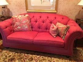 Red Tufted Sofa and Decorative Pillows