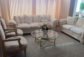 Sun Room:  White/pastel Oversized Sofa and Love Seat, 2 French Provincial light wood/upholstered Arm chairs, Brass/Glass coffee table and 2 matching end tables
