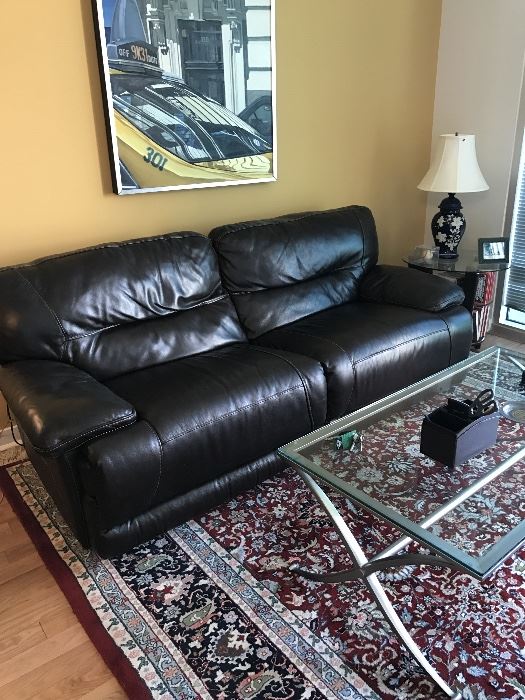 Dark brown leather sofa with pebble texture and top stitching. Two sections recline automatically. 87" long X 38" deep. In good condition. $400