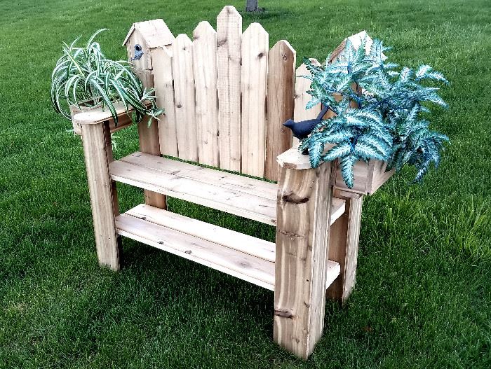 Outdoor bench has bird house & planters