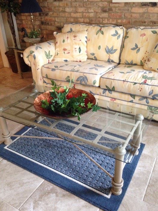 Garden room sofa has matching room divider and chair; glass top coffee table has a matching end table.