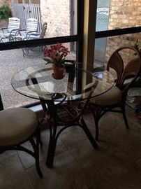 Rattan base/glass top table with 2 matching chairs