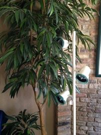 One of several artificial plants; pole lamp