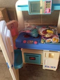 Child's kitchen with play food and dishes