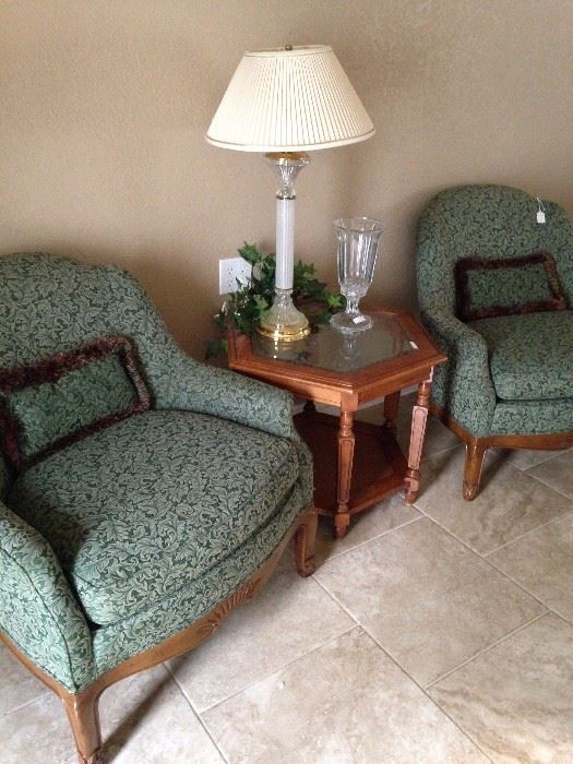 Good-looking matching green upholstered chairs; one of the several lamps