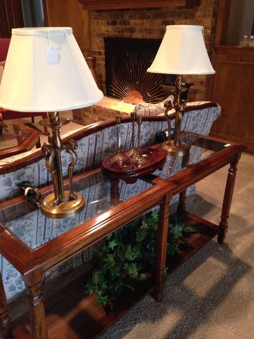 Two tiered glass top sofa table; pair of lamps