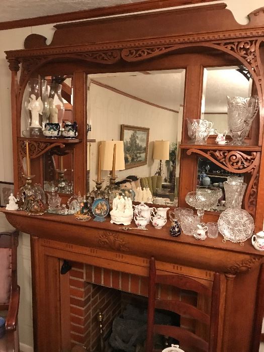 The mantle in the dining room is loaded with cut glass and decorative accessories spanning many periods