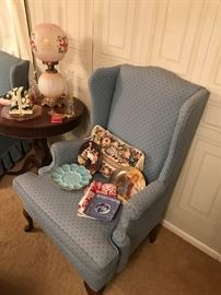 The house is so full that very inch of space is being used to display great items. A hard to find blue milk glass egg plate is next to hand painted collectors plates in this neat blue wing back chair. 
