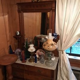 Neat oil lamps. Converted lamps. Victorian style lamps. All on a Victorian marble top dresser.