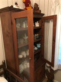 Great cabinet. Glass doors. Shelves are full. Milk glass and so much more.