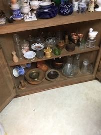 Another view of the corner cupboard with wood items, depresssion glass and crockware.