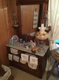 A Victorian marble top dresser holding lots of fun handmade linens.