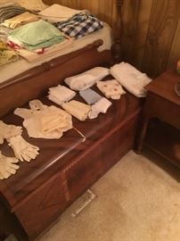 Vintage linens and gloves on top of a great old trunk.