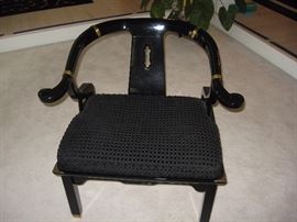 One of a pair of highly lacquered Chinese chairs with cushions.