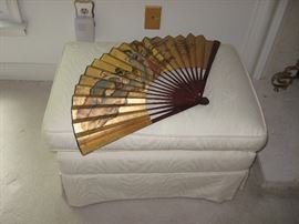 Cream upholstery ottoman and large fan