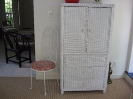 Wicker entertainment/storage cabinet and one of a pair of wrought iron chairs