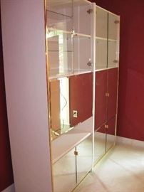 Two unit combination bar and entertainment center.  Mirrored doors and glass front shelves...