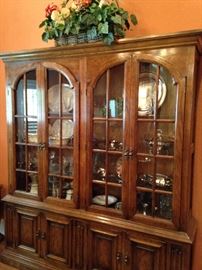 Large china cabinet filled with serving pieces, china, and crystal
