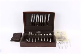 International Sterling Silver "Blossom Time" Flatware Set: A collection of International Silver Co. sterling silver flatware in the Blossom Time pattern. This fifty-four piece set includes eight dinner knives with stainless steel blades, eight dinner forks, eight salad forks, eighteen teaspoons, five serving spoons, a serving fork, a flat handle master butter knife, a gravy ladle, and four additional serving pieces. The pieces are marked to the underside of the handles. They are presented in a flatware chest. The total approximate weight of the set, exclusive of the eight dinner knives, is 58.799 ozt.