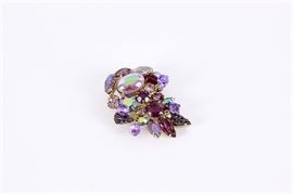 Weiss Purple Cluster Brooch: A Weiss purple cluster brooch. The brooch is comprised of gradient purple hue glass and faceted aurora borealis rhinestones. Set in a gold tone metal setting with pin fastener to back.