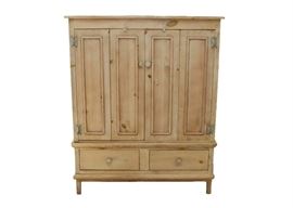 Rustic Pine Wardrobe: A rustic pine wardrobe. This wardrobe features a natural pine finish with two exterior jointed paneled doors to the top and two drawers to the bottom. The interior includes two shelves.