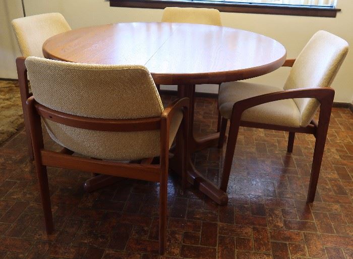Mid-Century Modern teak table and chairs; comes with two leaves and total of six chairs.