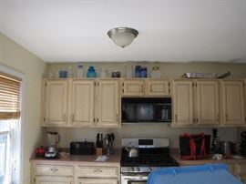 Now, isn't that a lovely kitchen with its off white/ivory antique-tone cabinets
