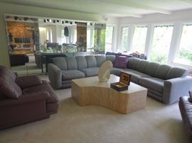 Ello Mirrored Wall unit, Directional Sofa, Purple Leather chairs, Stone Carved Coffee table. 