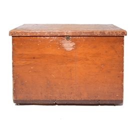 Antique Blanket Chest: An antique blanket chest. This antique blanket chest is constructed of pine and rest on four small casters. The chest features two pull handles to each side with a hinged lid and lock.
