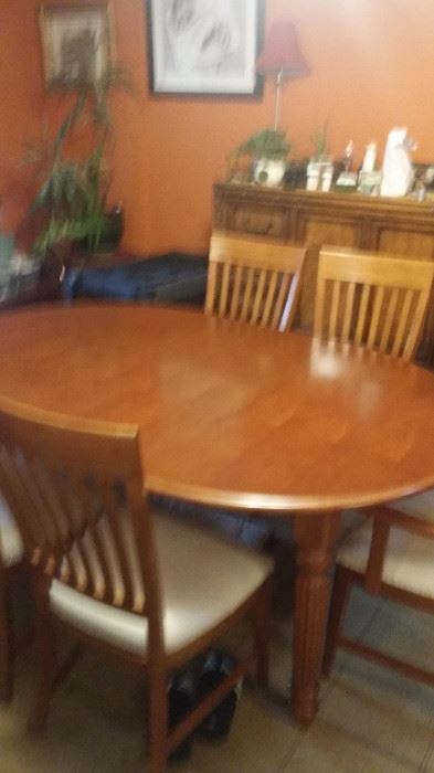 Honey color  walnut wood. This table set is in perfect condition and it has six chairs, two are captain style chairs. Gorgeous piece!
