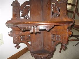 Carved birds on both side of corner shelf and base