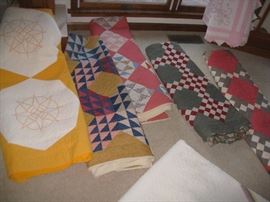 Numerous piecework quilts and one embroidered quilt