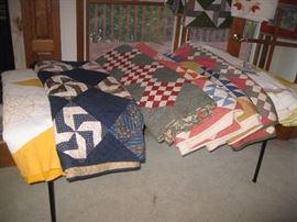 (2) Quilts on left are larger than all other quilts - possibly large Queens or Kings
