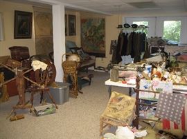 Spinning wheels, sofa, service uniforms in basement