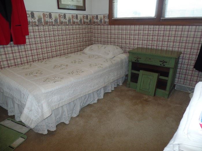 Twin bed and vintage green cabinet