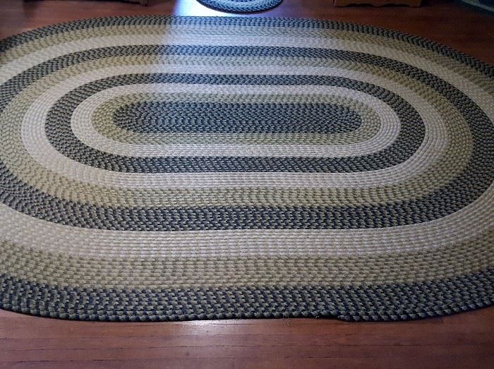 Braided rug in greens with small coordinating rugs
