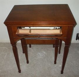 Front drawer opens for storage.